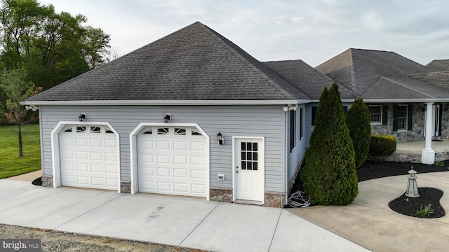 1081 Caldwell Corner Rd, Townsend, DE 19734 - view of side of property with an attached garage, roof with shingles, driveway, and stone siding