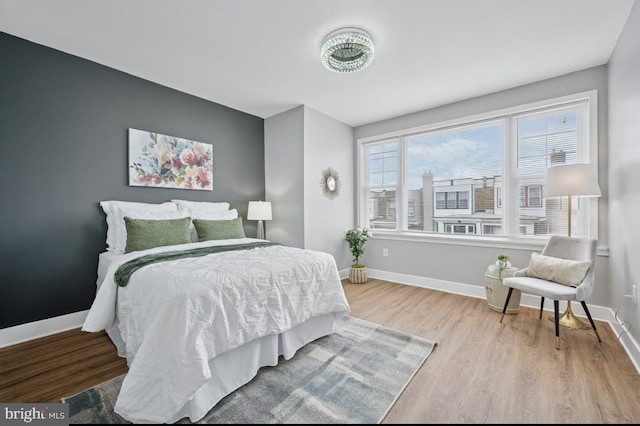 bedroom featuring baseboards and wood finished floors