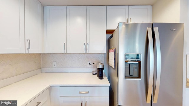 50 Florida Ave NE Unit 412, Washington, DC 20002 - kitchen with white cabinets, stainless steel fridge with ice dispenser, decorative backsplash, and light countertops