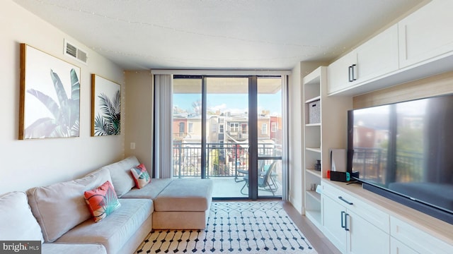 50 Florida Ave NE Unit 412, Washington, DC 20002 - living area with light wood-type flooring, expansive windows, and visible vents
