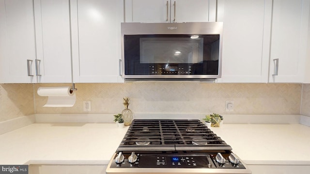 50 Florida Ave NE Unit 412, Washington, DC 20002 - kitchen featuring stove, light countertops, stainless steel microwave, and white cabinetry