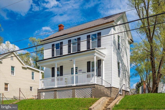 713 3rd St, Martinsburg, WV 25404 - colonial house featuring stairway, covered porch, a front lawn, and metal roof