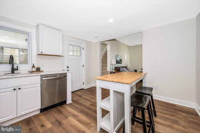 713 3rd St, Martinsburg, WV 25404 - kitchen featuring stainless steel dishwasher, white cabinets, a sink, baseboards, and dark wood-style floors