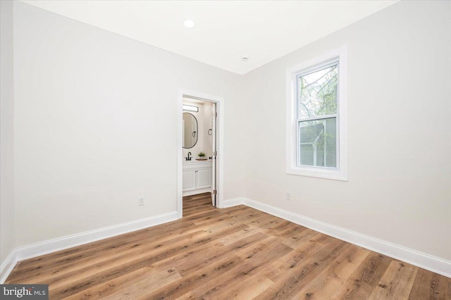 713 3rd St, Martinsburg, WV 25404 - spare room with a sink, light wood finished floors, and baseboards