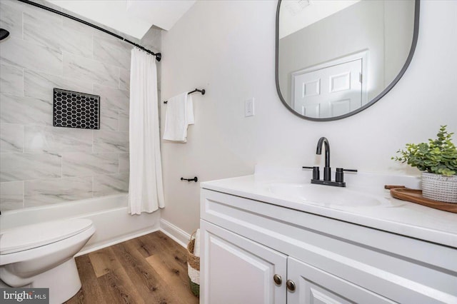 713 3rd St, Martinsburg, WV 25404 - full bath featuring vanity, baseboards, shower / bath combo, toilet, and wood finished floors