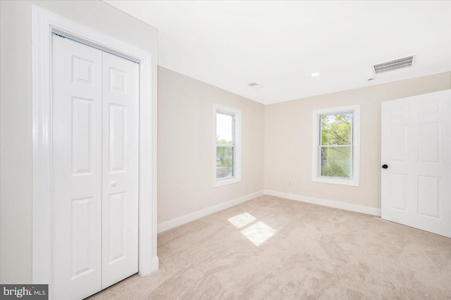 713 3rd St, Martinsburg, WV 25404 - unfurnished bedroom with light carpet, a closet, baseboards, and visible vents