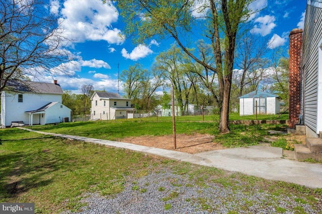 713 3rd St, Martinsburg, WV 25404 - view of yard featuring fence, an outdoor structure, and a shed