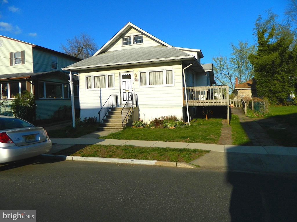 bungalow-style house with roof with shingles