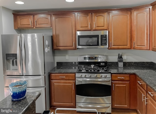 920 Pine Forest Ln Unit 1812, Upper Marlboro, MD 20774 - kitchen featuring stainless steel appliances, brown cabinetry, and dark stone countertops