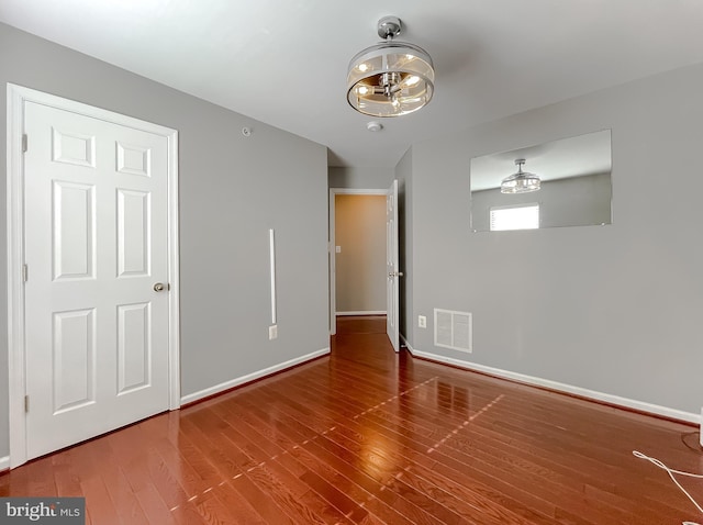 920 Pine Forest Ln Unit 1812, Upper Marlboro, MD 20774 - empty room with baseboards, a notable chandelier, visible vents, and wood finished floors