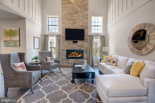 126 Green Forest Dr Unit 5Houston, Middletown, DE 19709 - living room featuring a high ceiling, a stone fireplace, wood finished floors, and plenty of natural light