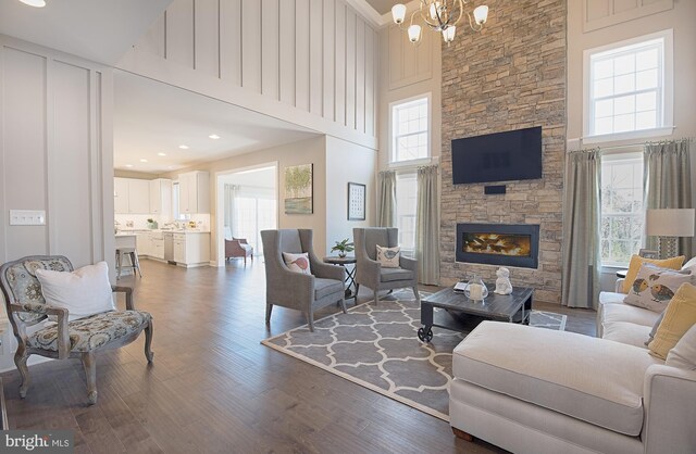 126 Green Forest Dr Unit 5Houston, Middletown, DE 19709 - living area featuring a wealth of natural light, a high ceiling, dark wood-type flooring, and a notable chandelier