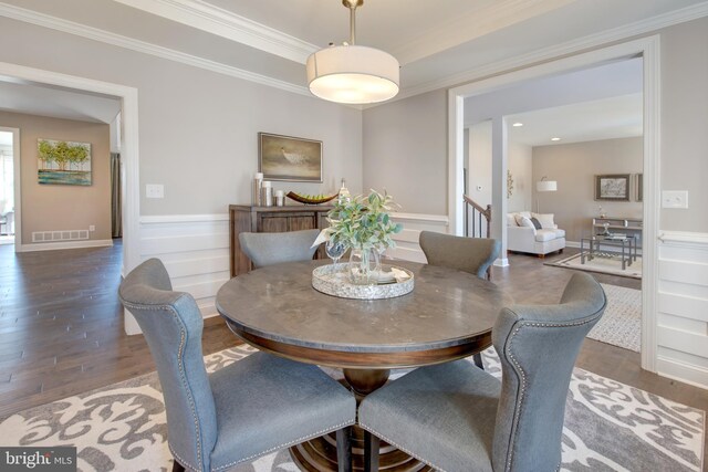 126 Green Forest Dr Unit 5Houston, Middletown, DE 19709 - dining room featuring visible vents, crown molding, wood finished floors, a wainscoted wall, and a decorative wall