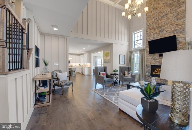 126 Green Forest Dr Unit 5Houston, Middletown, DE 19709 - living area featuring a high ceiling, a notable chandelier, a fireplace, wood finished floors, and stairway