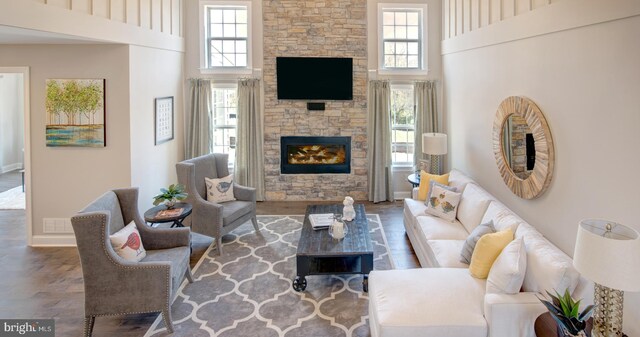 126 Green Forest Dr Unit 5Houston, Middletown, DE 19709 - living room with baseboards, a high ceiling, a stone fireplace, and wood finished floors