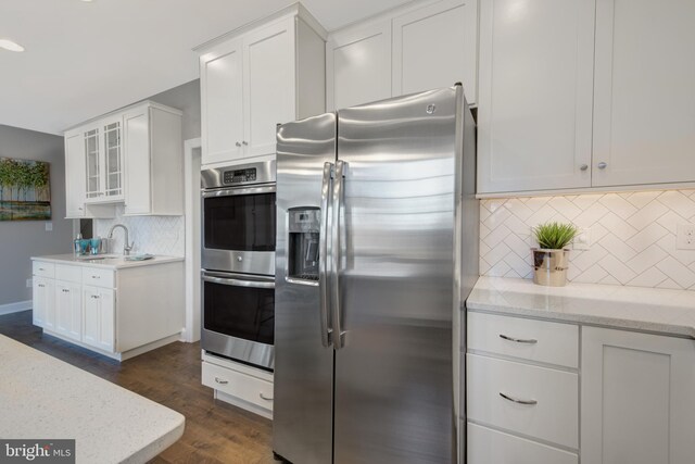 126 Green Forest Dr Unit 5Houston, Middletown, DE 19709 - kitchen featuring a sink, white cabinetry, tasteful backsplash, and stainless steel appliances