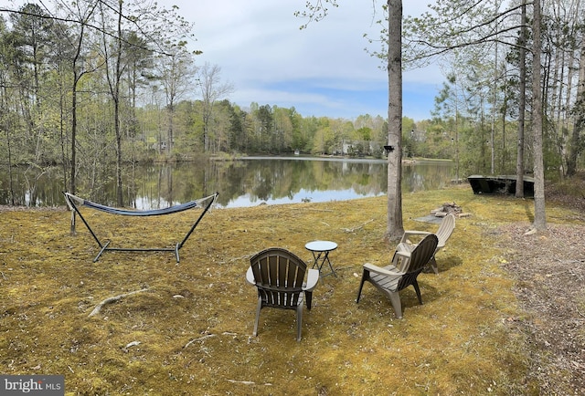 view of yard with a water view and a wooded view