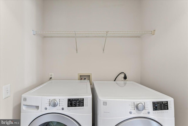 laundry area featuring separate washer and dryer and laundry area