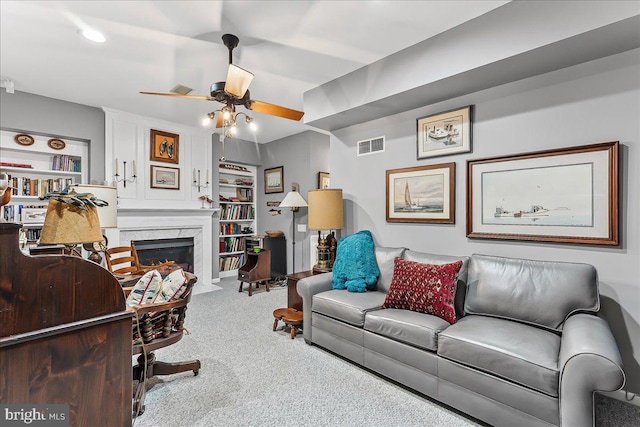 living room featuring a fireplace, carpet, visible vents, and ceiling fan