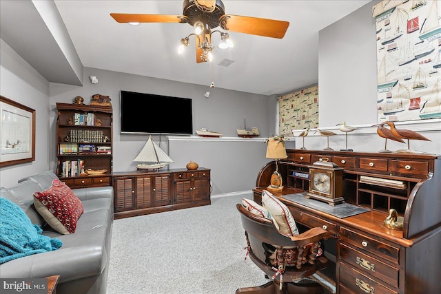office space featuring carpet, ceiling fan, visible vents, and baseboards