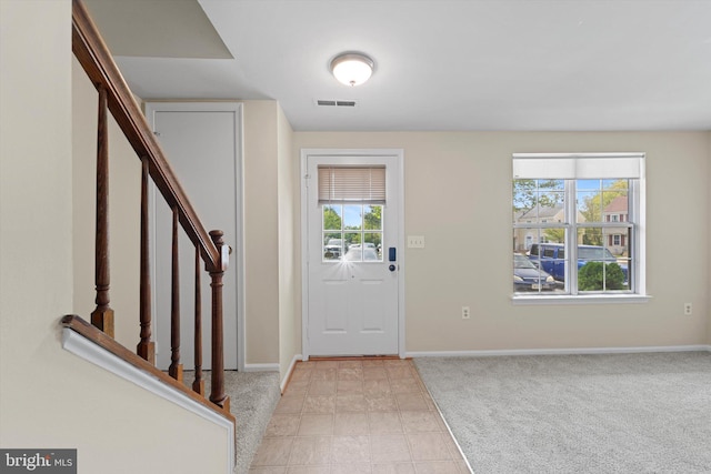 entryway with stairway, visible vents, and baseboards