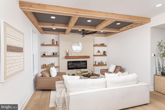 living area featuring ceiling fan, coffered ceiling, beam ceiling, and baseboards