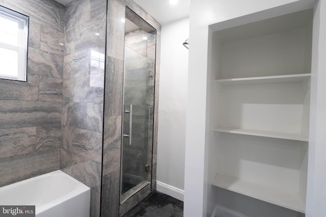 full bath with a stall shower, a bathtub, and baseboards