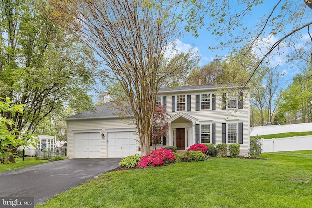 26 Blossom Wood Ct, Stafford, VA 22554 - colonial home featuring driveway, fence, an attached garage, and a front lawn