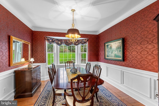26 Blossom Wood Ct, Stafford, VA 22554 - dining area with ornamental molding, a wainscoted wall, light wood-type flooring, and an inviting chandelier