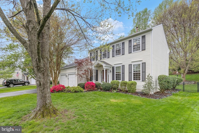 26 Blossom Wood Ct, Stafford, VA 22554 - colonial-style house with a garage, driveway, fence, and a front lawn