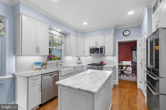 26 Blossom Wood Ct, Stafford, VA 22554 - kitchen with stainless steel appliances, light stone countertops, white cabinetry, and a sink