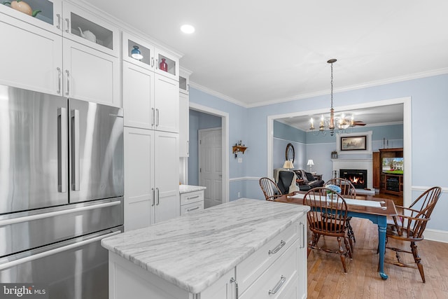 26 Blossom Wood Ct, Stafford, VA 22554 - kitchen with a notable chandelier, freestanding refrigerator, crown molding, white cabinetry, and light wood finished floors