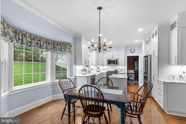 26 Blossom Wood Ct, Stafford, VA 22554 - dining space featuring baseboards, an inviting chandelier, ornamental molding, visible vents, and light wood finished floors