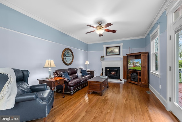 26 Blossom Wood Ct, Stafford, VA 22554 - living area featuring light wood-style floors, a fireplace, crown molding, and a ceiling fan
