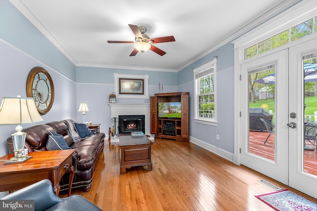 26 Blossom Wood Ct, Stafford, VA 22554 - living room featuring light wood-style floors, crown molding, a fireplace, a ceiling fan, and visible vents
