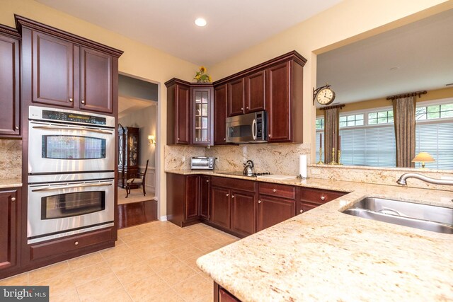 106 Mahogany Way, Upper Gwynedd, PA 19446 - kitchen featuring a sink, decorative backsplash, appliances with stainless steel finishes, light stone countertops, and light tile patterned floors