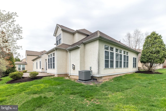 106 Mahogany Way, Upper Gwynedd, PA 19446 - back of house with stucco siding, a yard, roof with shingles, and central AC unit
