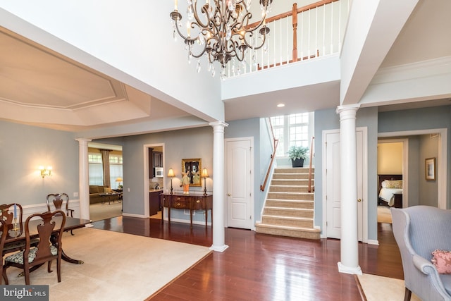 106 Mahogany Way, Upper Gwynedd, PA 19446 - foyer entrance with decorative columns, wood finished floors, an inviting chandelier, and stairway