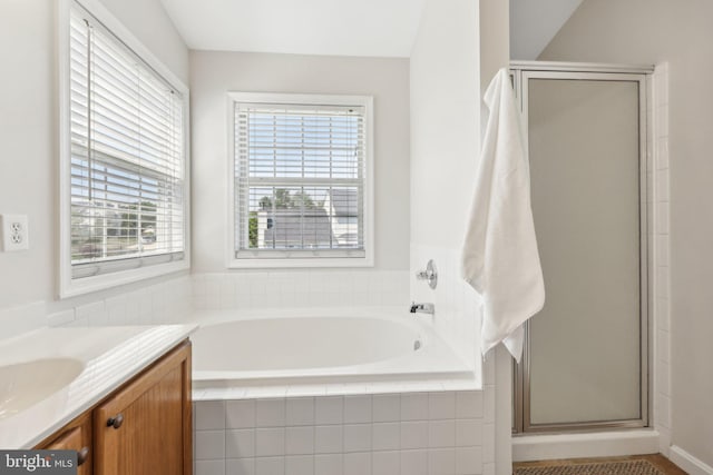 bathroom featuring vanity, a stall shower, and a bath