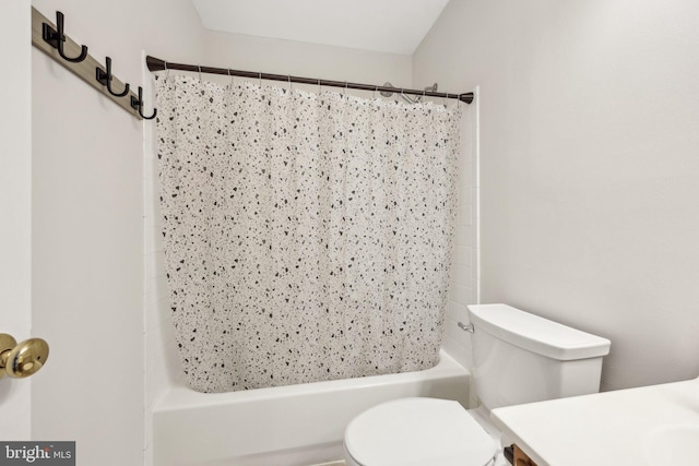bathroom with shower / bath combo with shower curtain, toilet, and vanity