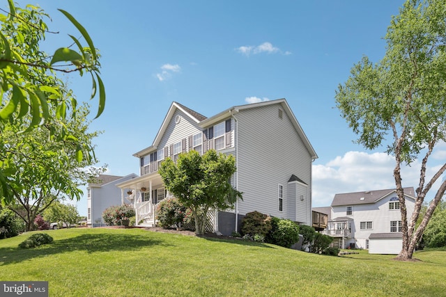 view of property exterior featuring a lawn and a porch