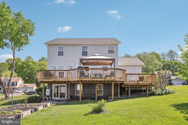 back of house featuring a lawn, a gazebo, a vegetable garden, and a deck