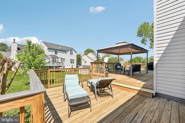 wooden deck featuring outdoor dining area and a gazebo