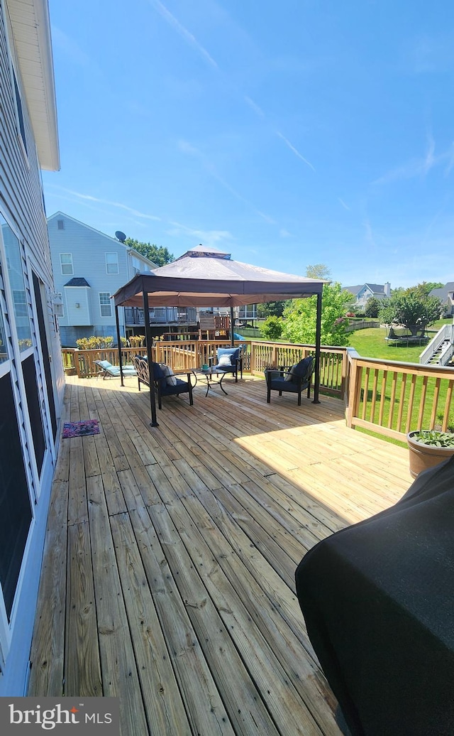 wooden terrace featuring a gazebo