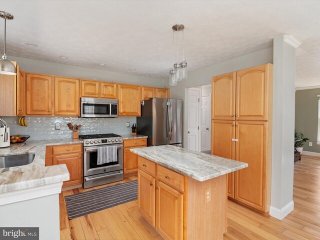 2311 Crosslanes Way, Odenton, MD 21113 - kitchen featuring light wood-style flooring, light stone counters, backsplash, and appliances with stainless steel finishes