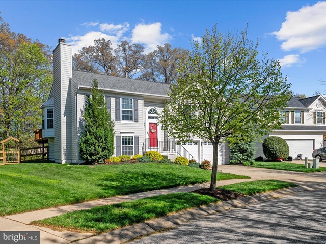 2311 Crosslanes Way, Odenton, MD 21113 - raised ranch featuring concrete driveway, a front lawn, fence, and a chimney