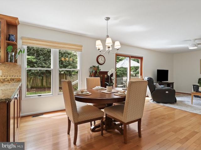 dining room featuring an inviting chandelier, visible vents, and light wood finished floors
