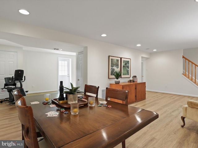 dining room with stairway, light wood-style floors, and recessed lighting