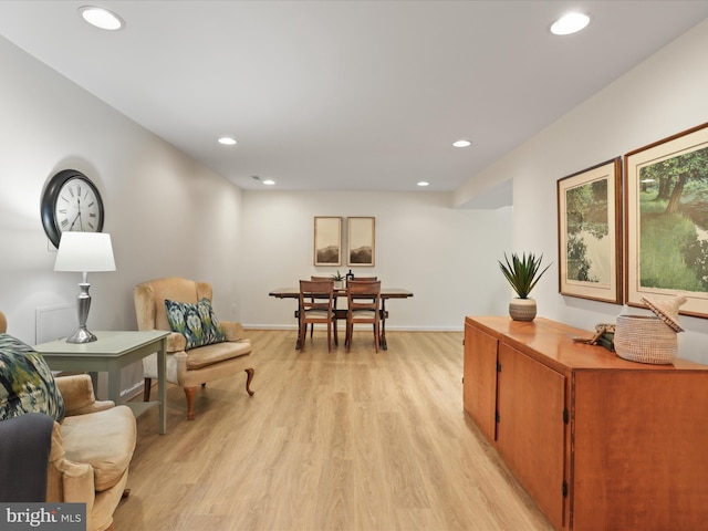 sitting room featuring baseboards, recessed lighting, and light wood-style floors