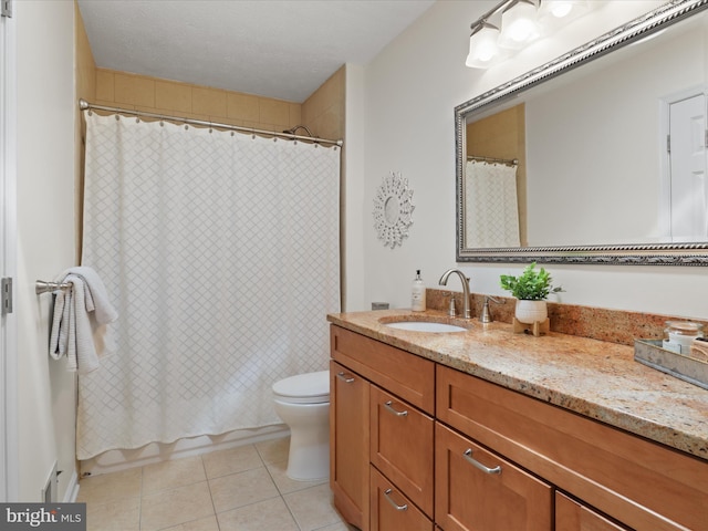 bathroom featuring tile patterned floors, shower / tub combo, vanity, and toilet